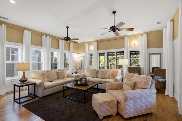 living room featuring ceiling fan and light hardwood / wood-style flooring