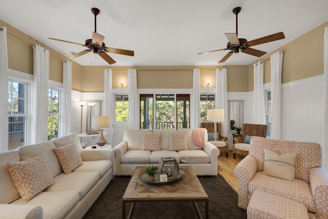 living room with ceiling fan and dark hardwood / wood-style flooring