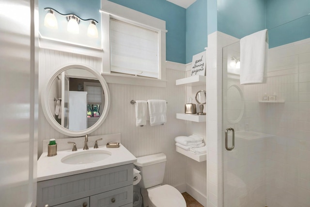 bathroom with toilet, walk in shower, and vanity