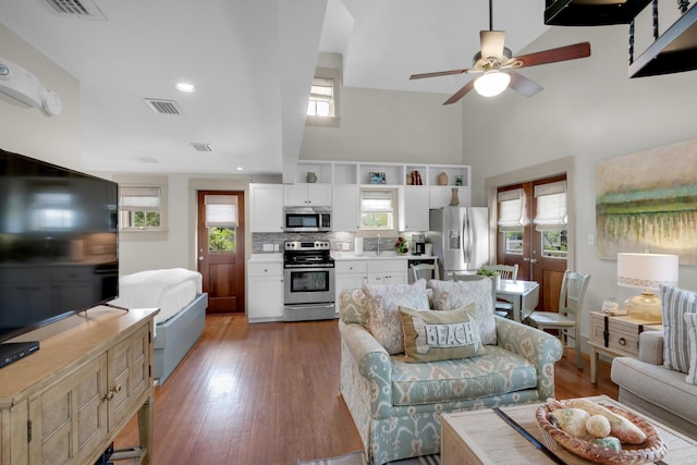 living room with ceiling fan, wood-type flooring, and sink