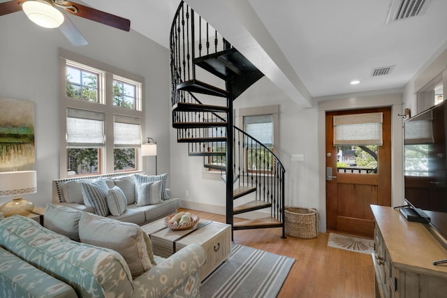 living room with light wood-type flooring and ceiling fan