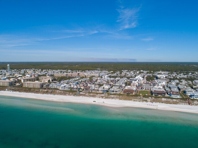 drone / aerial view featuring a beach view and a water view