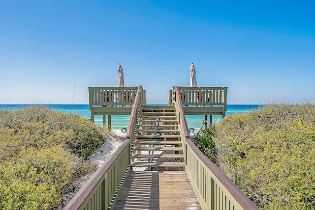 view of home's community with a beach view and a water view