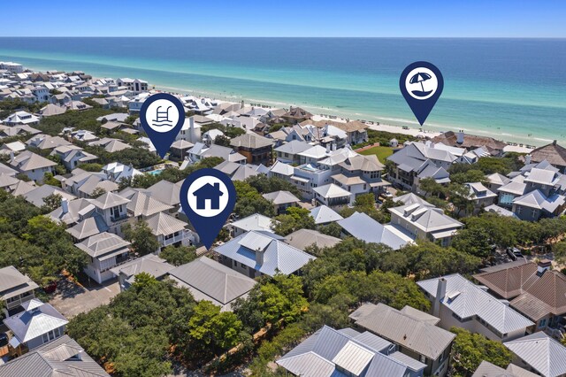 drone / aerial view featuring a beach view and a water view