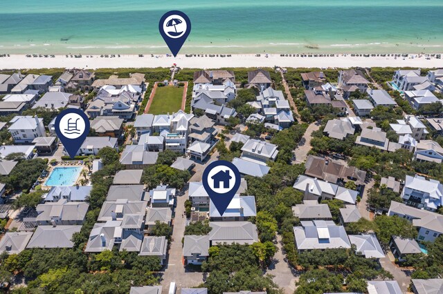 drone / aerial view featuring a beach view and a water view