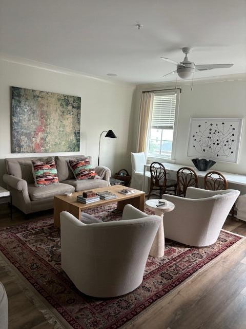 living room featuring ceiling fan and hardwood / wood-style flooring