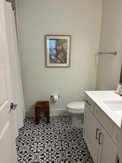 bathroom featuring vanity, toilet, and tile patterned flooring