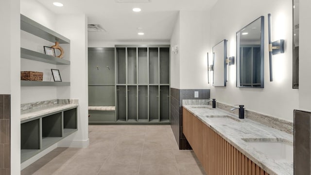 bathroom with dual vanity and tile patterned flooring