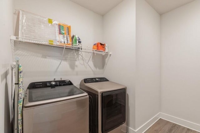 washroom featuring washer and clothes dryer and dark hardwood / wood-style floors