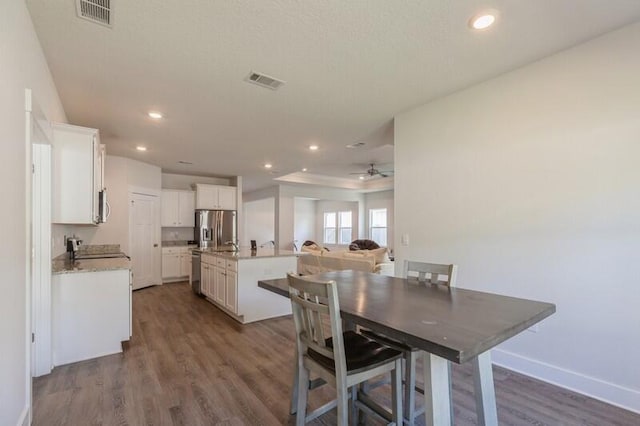 dining space with ceiling fan and dark hardwood / wood-style floors