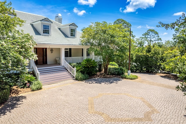 new england style home with a porch