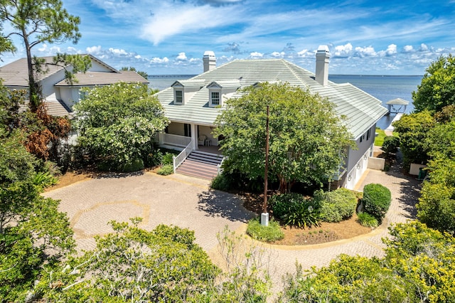 view of front facade with a water view and covered porch