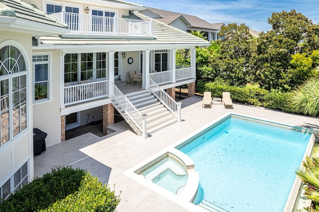 view of swimming pool with an in ground hot tub and a patio