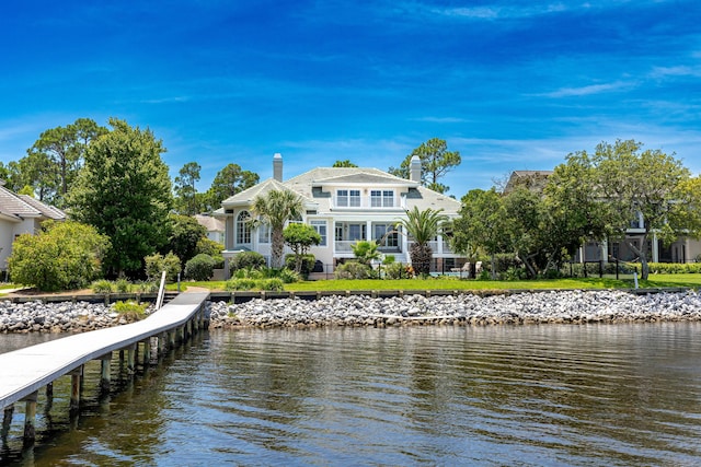 rear view of property featuring a yard and a water view