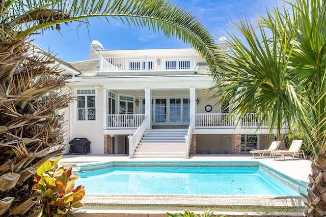 view of swimming pool with a grill and a patio area