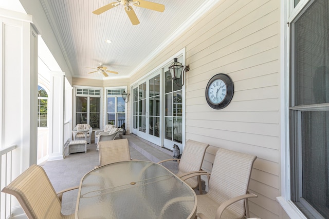 sunroom with wood ceiling and ceiling fan