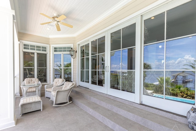 sunroom / solarium featuring wood ceiling, ceiling fan, and plenty of natural light