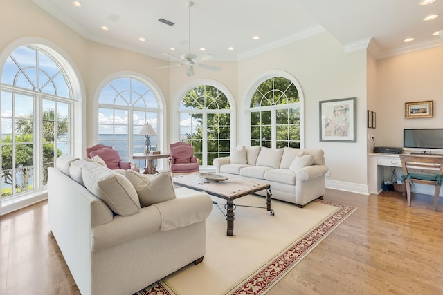 living room featuring a water view, ceiling fan, crown molding, and light hardwood / wood-style flooring