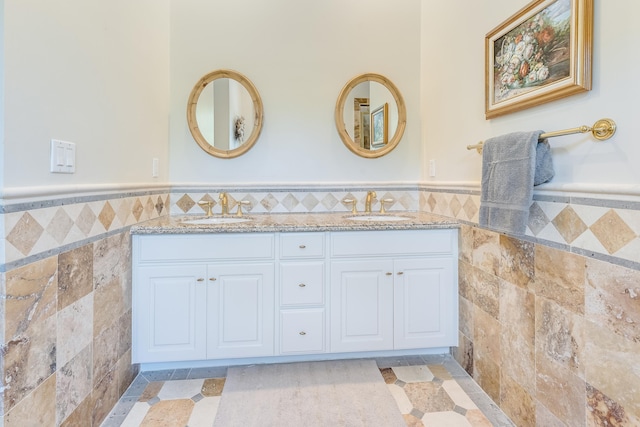 bathroom with vanity and tile walls