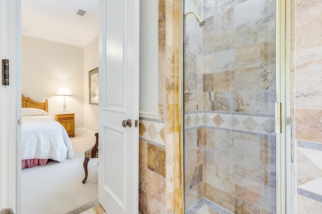 bathroom with a shower with door and crown molding