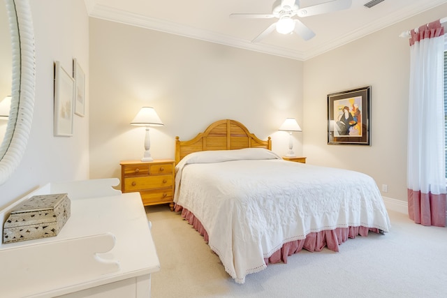 carpeted bedroom featuring ceiling fan and ornamental molding