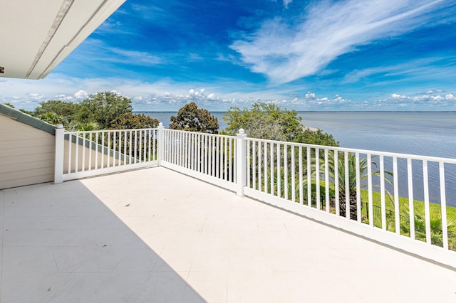 view of patio / terrace featuring a water view and a balcony