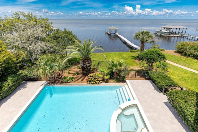 view of pool featuring a water view, a boat dock, and a lawn