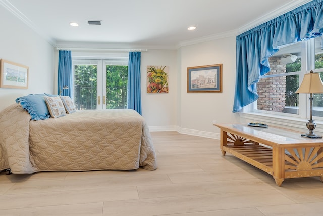 bedroom with crown molding and light hardwood / wood-style flooring