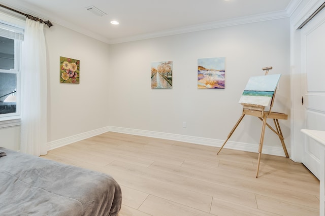 bedroom featuring ornamental molding and light hardwood / wood-style floors