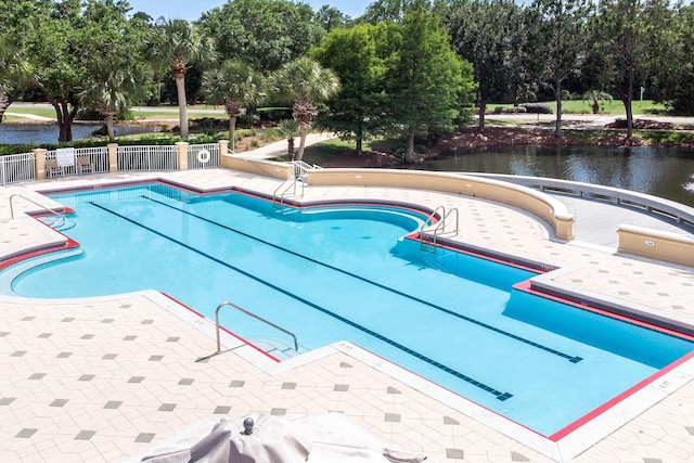 view of swimming pool with a water view