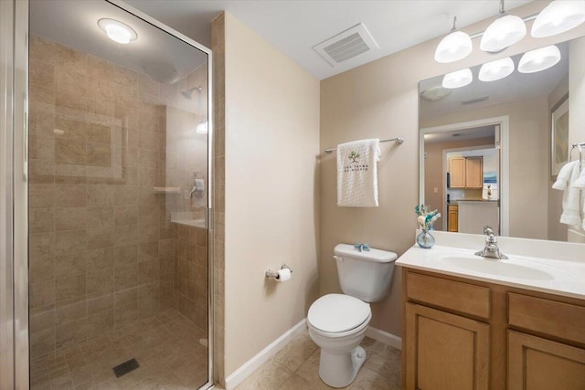 bathroom featuring vanity, a shower with shower door, and toilet