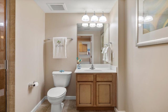 bathroom with tile patterned floors, vanity, toilet, and a shower with door