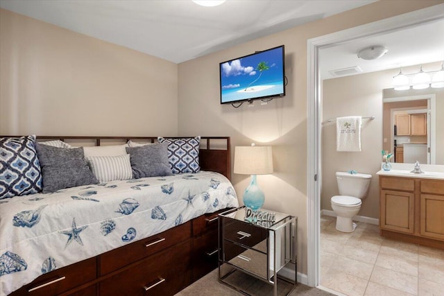 tiled bedroom with sink and connected bathroom