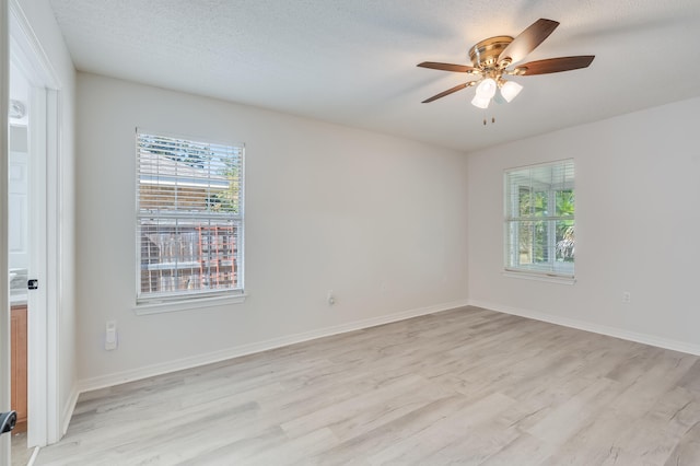 unfurnished room featuring light hardwood / wood-style flooring, a textured ceiling, and ceiling fan