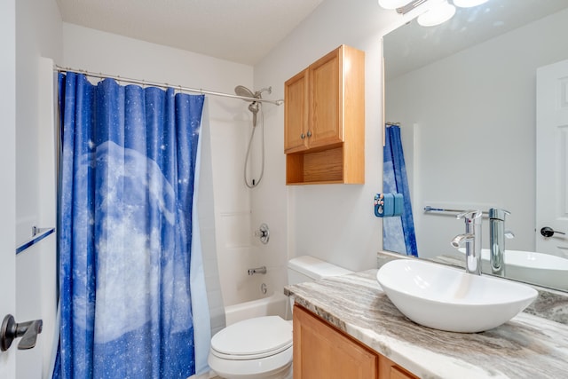 full bathroom featuring vanity, a textured ceiling, shower / bath combo with shower curtain, and toilet