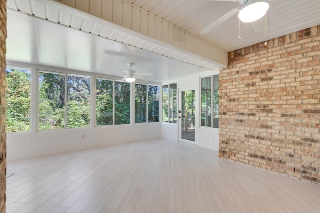 unfurnished sunroom featuring ceiling fan