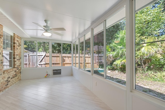 unfurnished sunroom featuring an AC wall unit and ceiling fan