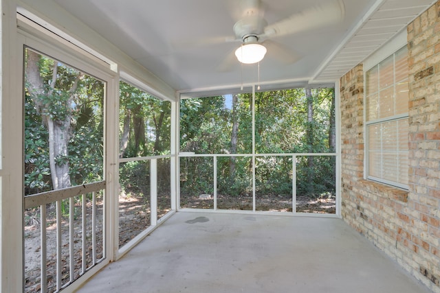 unfurnished sunroom with ceiling fan