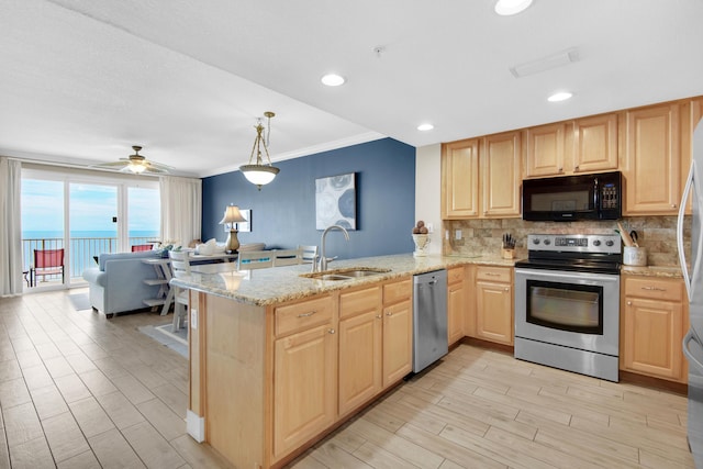 kitchen with a water view, hanging light fixtures, sink, kitchen peninsula, and stainless steel appliances