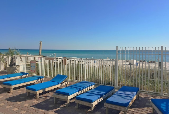 view of patio / terrace featuring a beach view and a water view