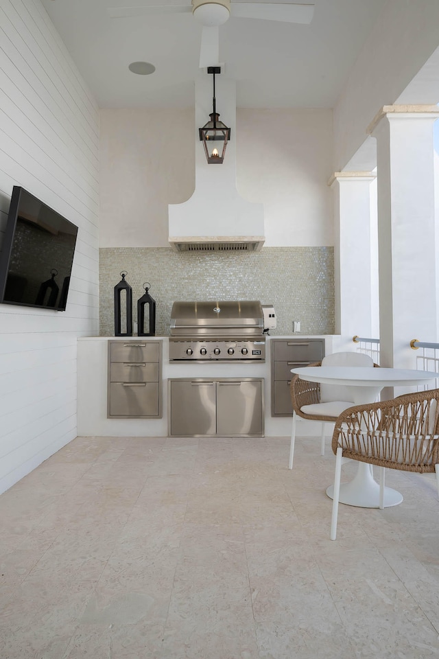 kitchen featuring custom exhaust hood, decorative light fixtures, tile patterned floors, and decorative backsplash