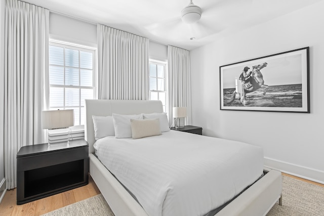 bedroom with ceiling fan and light hardwood / wood-style floors