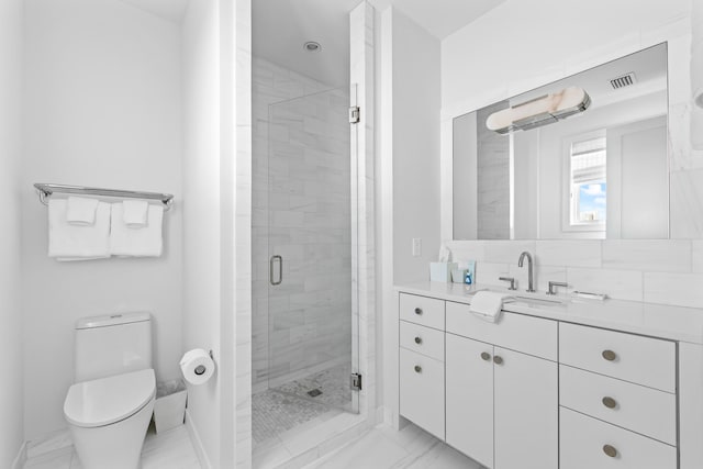 bathroom featuring tile patterned flooring, toilet, a shower with door, and vanity