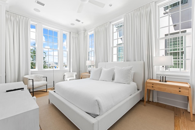 bedroom with light hardwood / wood-style flooring and ceiling fan