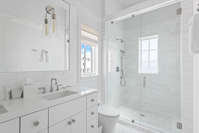 bathroom featuring vanity, toilet, an enclosed shower, and tile walls