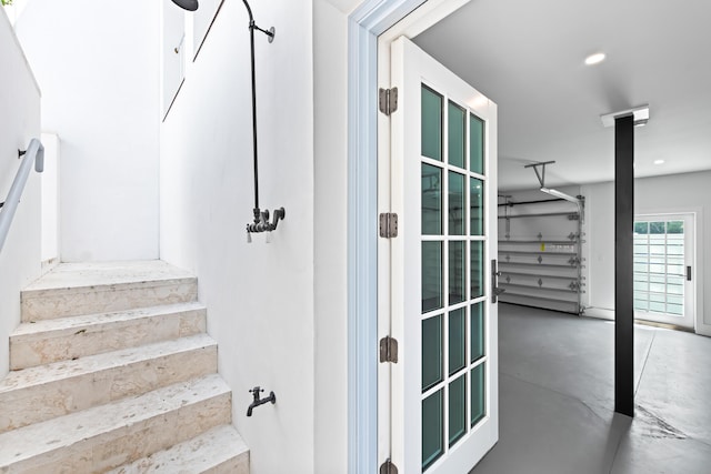 stairs featuring concrete flooring