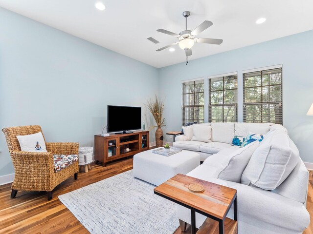 living room featuring ceiling fan and wood-type flooring