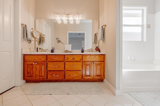 bathroom featuring tile patterned floors, double vanity, a bathtub, and a sink