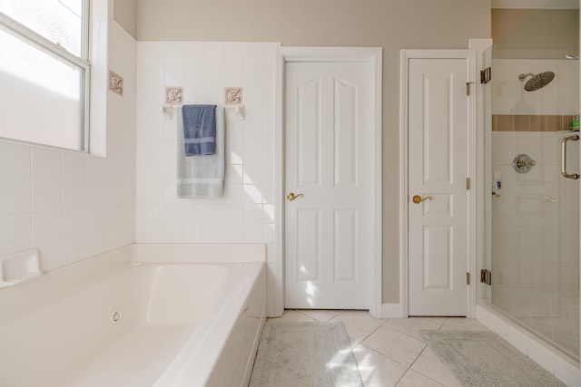 bathroom featuring a garden tub, a stall shower, and tile patterned flooring