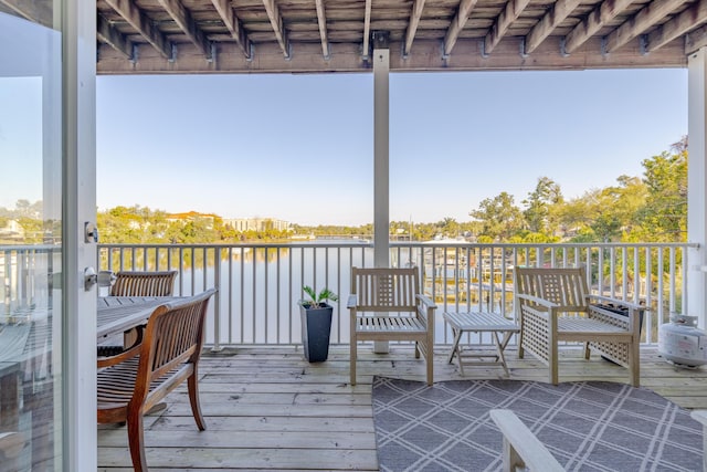 wooden terrace featuring a water view